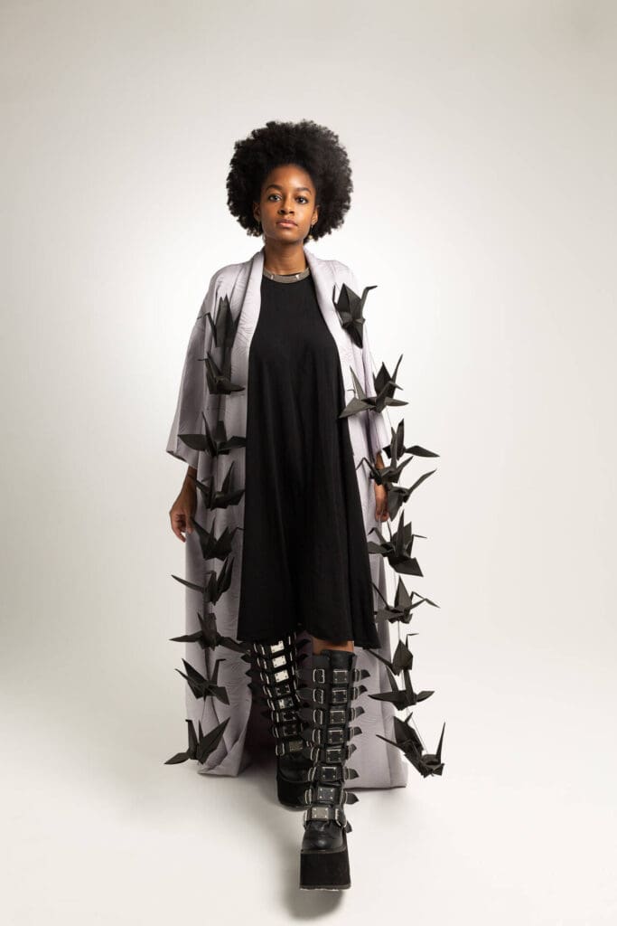 Indoor headshot of a model wearing a long shirt with many paper bats attached to it - Tokyo Portrait Photographer